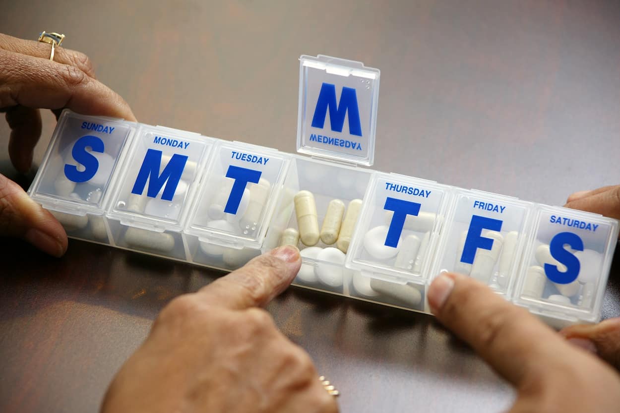 medication management with daily pill container