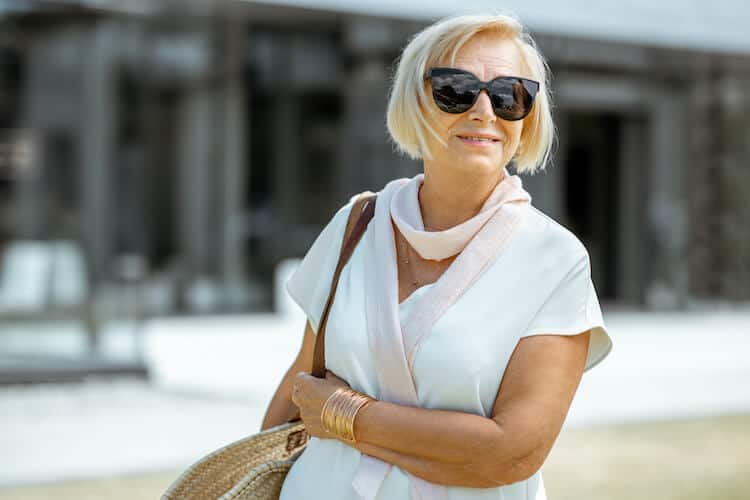 Senior woman wearing sunglasses as a way to care for her eyes.