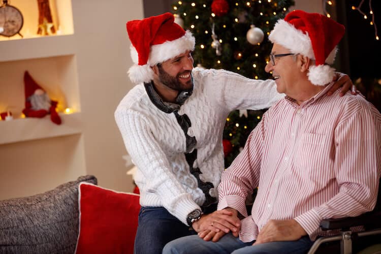 Elderly man and adult son spending the holidays together.