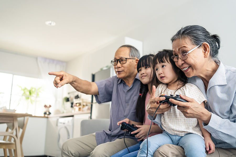 Grandkids playing video games with their grandparents