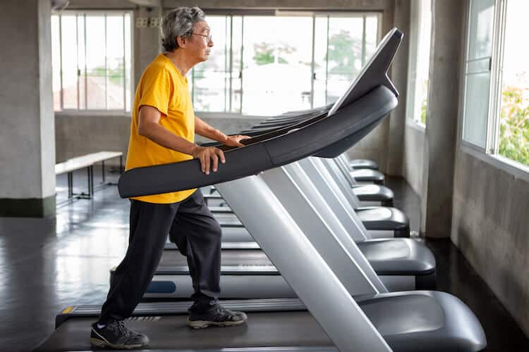 Senior man exercising on treadmill.