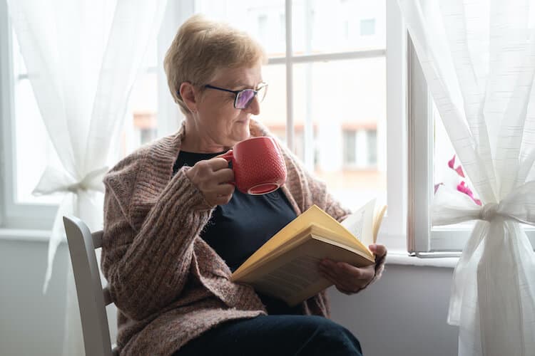 Senior woman relaxing in her senior living home.