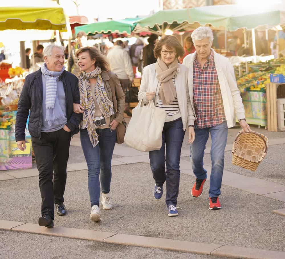 Two senior couples walking back from the farmers market