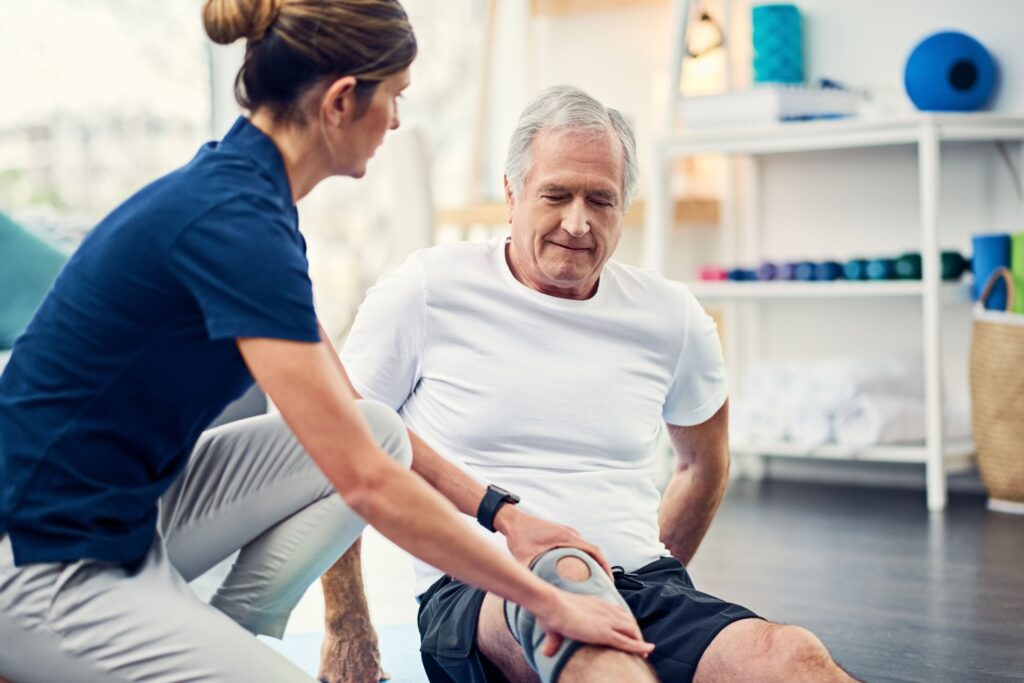working with senior male at rehab