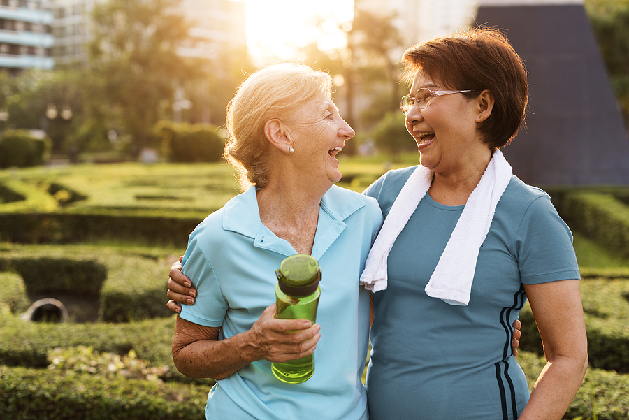 Two woman hugging and smiling together.