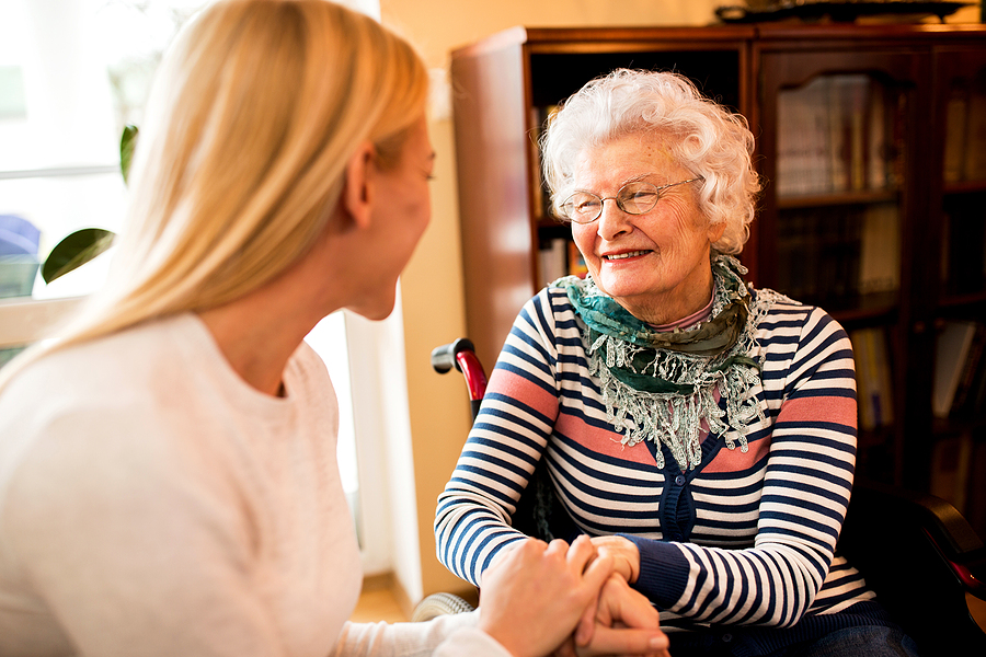 Granddaughter visits senior grandmother in a memory care community