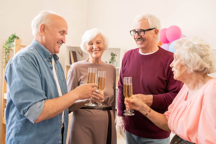Senior friends toasting champagne.